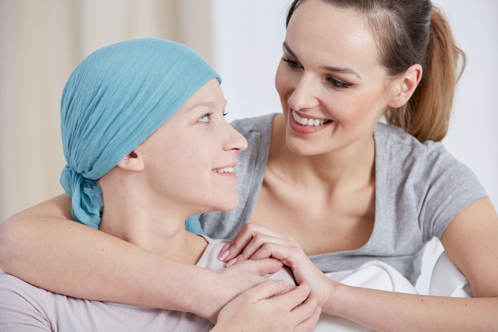 woman hugging another woman with cancer
