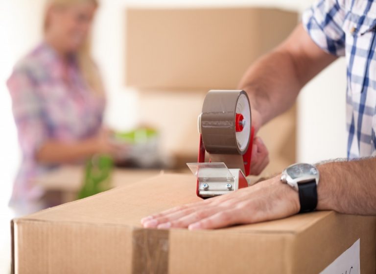 man packing a box