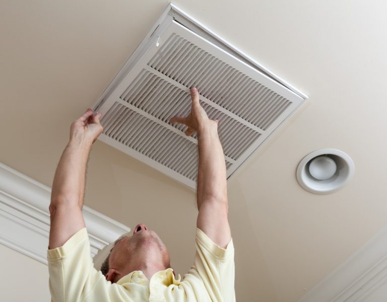 man checking the air duct