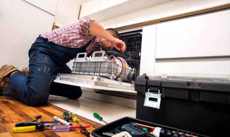 man fixing the dishwasher