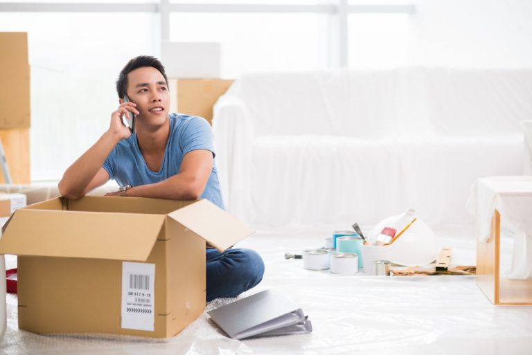 man calling resting on box