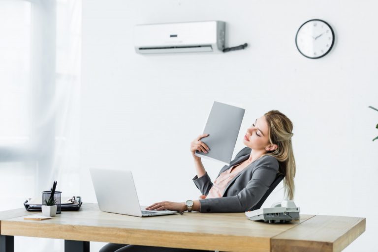 woman fanning herself because of heat