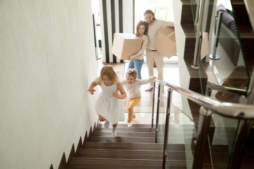 children excitedly climbing the stairs of their new rental house