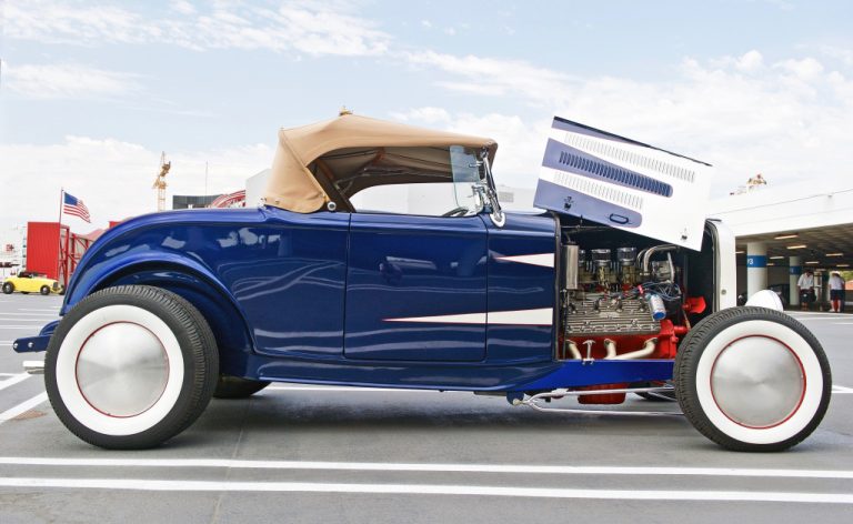 blue vintage car with engine shown